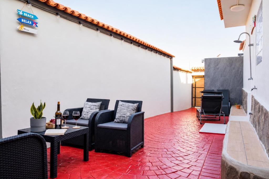 a patio with black furniture and a red brick floor at Private Terrace, Residential Area, Beach & Surf, El Médano in El Médano