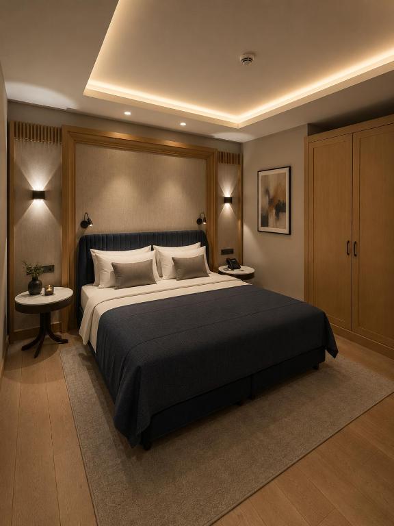 a bedroom with a large bed and two tables at Cher Hotel Eyüp in Istanbul