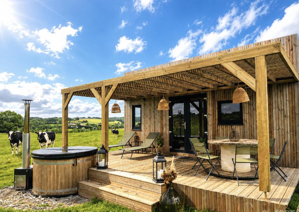 a house with a wooden deck with a hot tub at L'instant bucolique in Origny-en-Thiérache