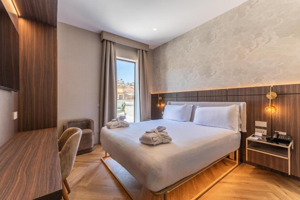 a hotel room with a bed and a window at Hotel Raffaello - Sure Hotel Collection by Best Western in Rome
