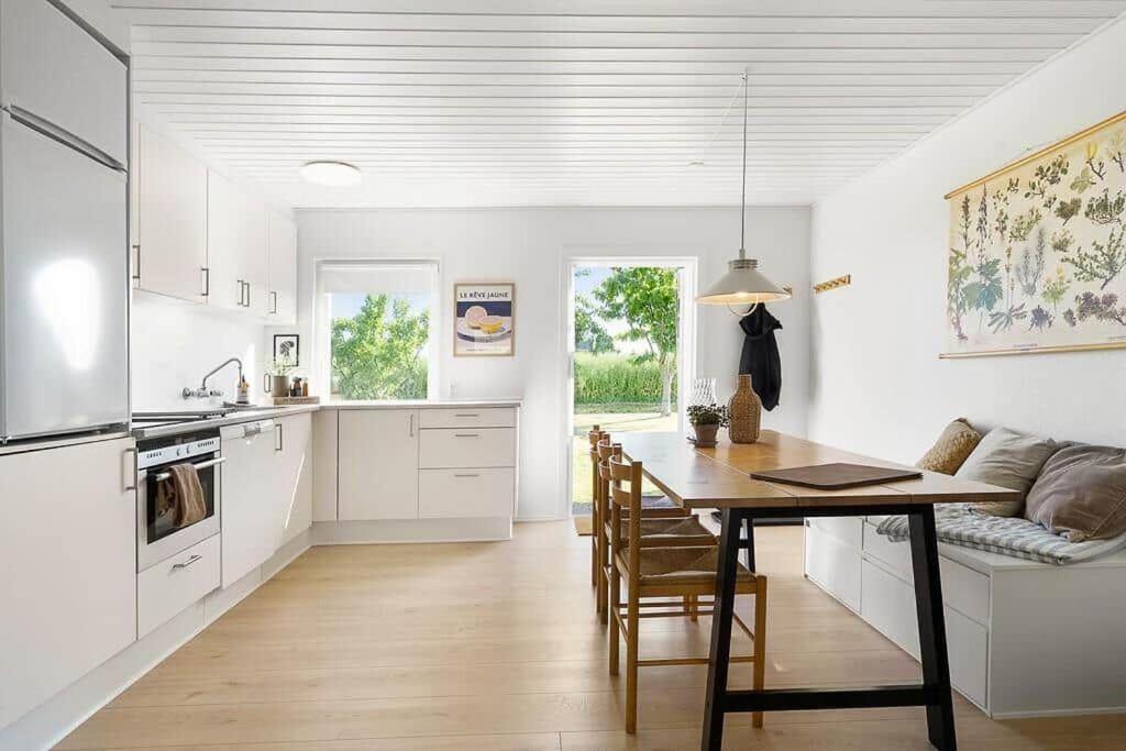 a kitchen and dining room with a table and a couch at SB134-Sydals-Osterbyvej-54-B in Østerby
