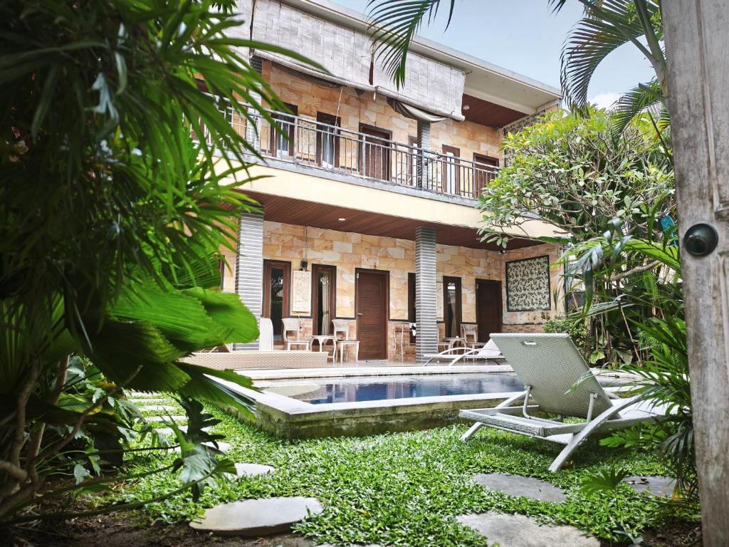 a villa with a swimming pool and a resort at Sun Homestay Canggu in Canggu