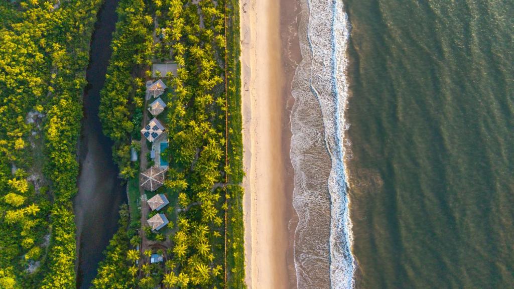 an overhead view of a beach and the ocean at Reserva Pratigi in Ituberá