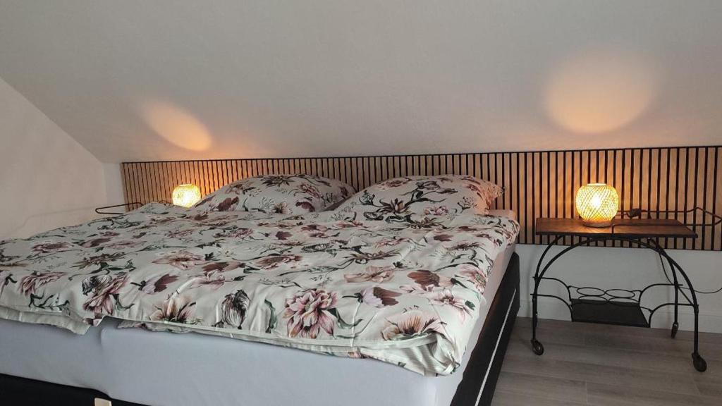 a bed in a bedroom with two lamps on tables at Bergblick2 in Zell an der Mosel