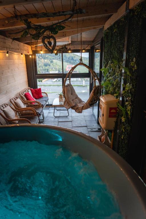 a bath tub filled with blue water in a room at Słoneczny Stok in Międzybrodzie Żywieckie