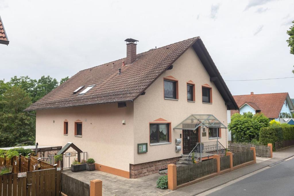 a white house with a brown roof at Fewo Krick in Bad Soden-Salmünster