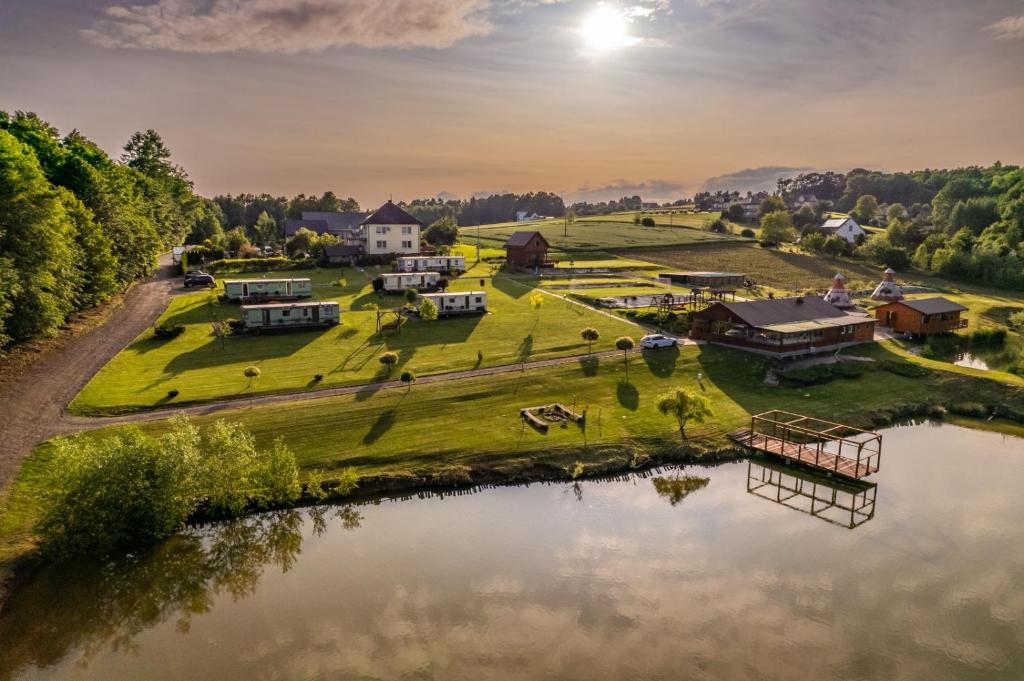 an aerial view of a farm with a pond at Leśny Zakątek Radocza in Radocza