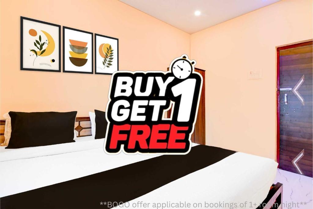 a bedroom with a buy get free sign on a bed at Hotel O Agarpara Railway Station Road Formerly Chowdhury Guest House in kolkata