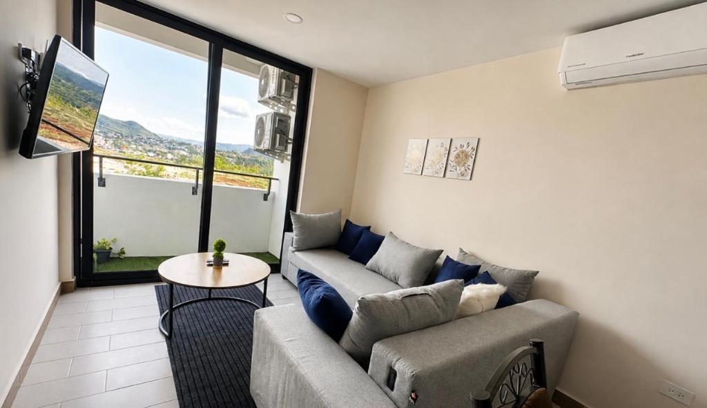a living room with a couch and a table at Angies Loft in Tegucigalpa