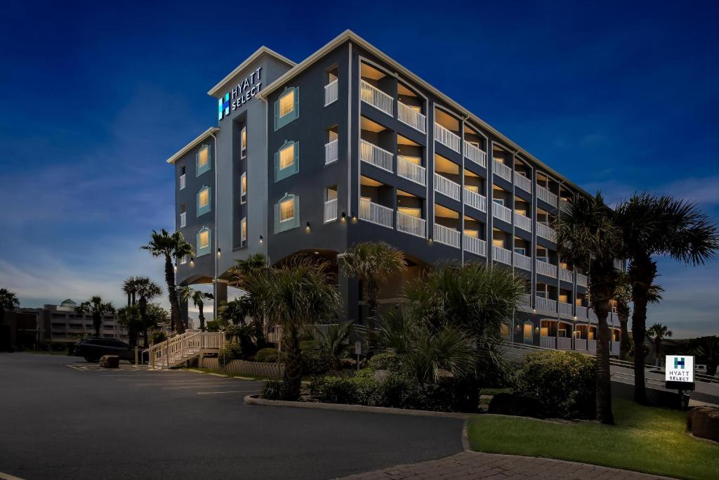 an exterior view of the hotel at night at Hyatt Select Galveston Beachfront in Galveston