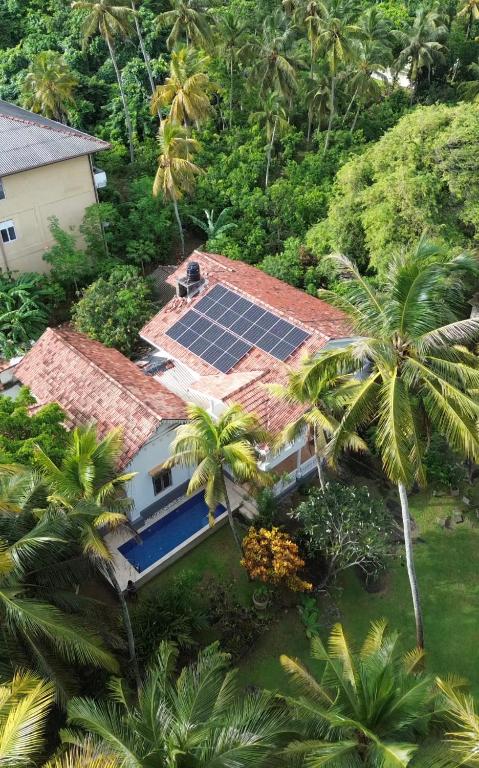 an aerial view of a house with solar panels on the roof at Villa Balapitiya Beach in Balapitiya