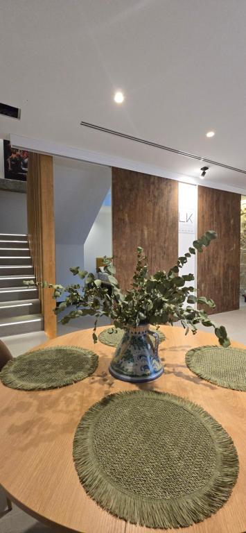 a table with a vase with a plant on it at La Kasilla in Baeza