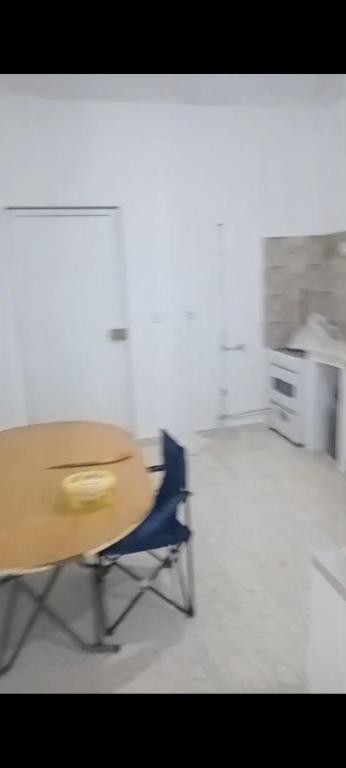 a wooden desk and a blue chair in an office at Najib in Djerba