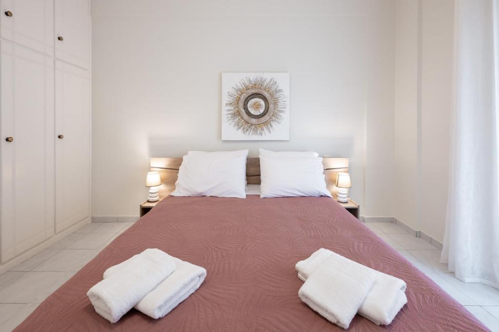 a bedroom with a large bed with two white pillows at Makis Apartments in Tsoukalades