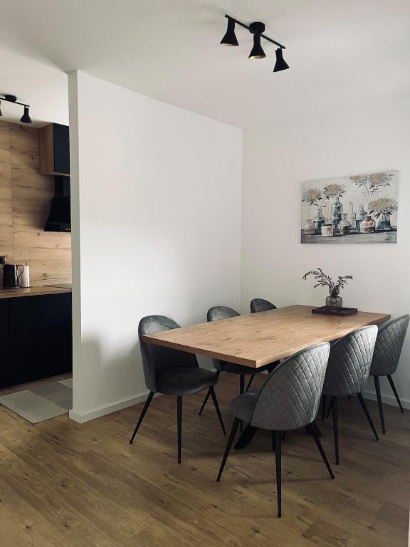 a dining room with a wooden table and chairs at SunnyOasis in Mostar