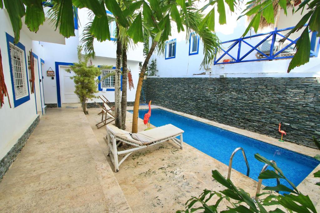 a chair next to a swimming pool with a palm tree at Bayahibe Premium Pool in Bayahibe