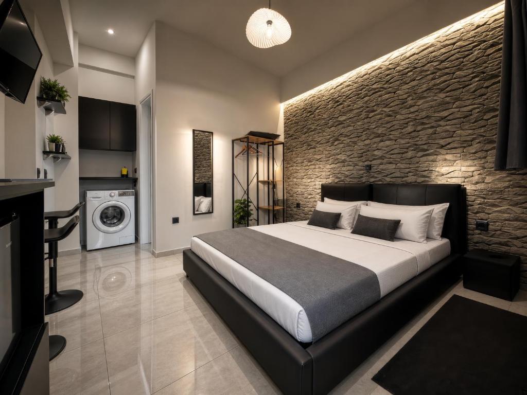 a bedroom with a bed and a brick wall at ILoveHome Mini in Kalamata