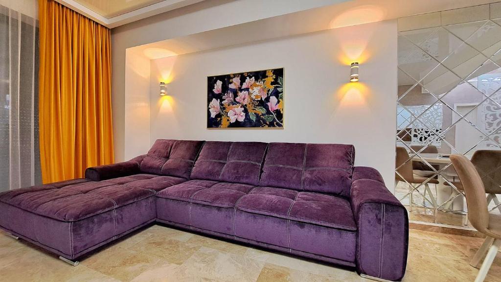 a large purple couch in a living room at KYA Luxury in Mamaia