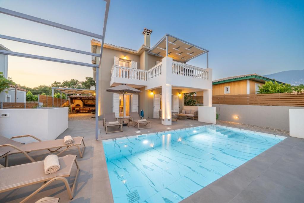 a villa with a swimming pool and a house at Villa Mary in Kefallonia