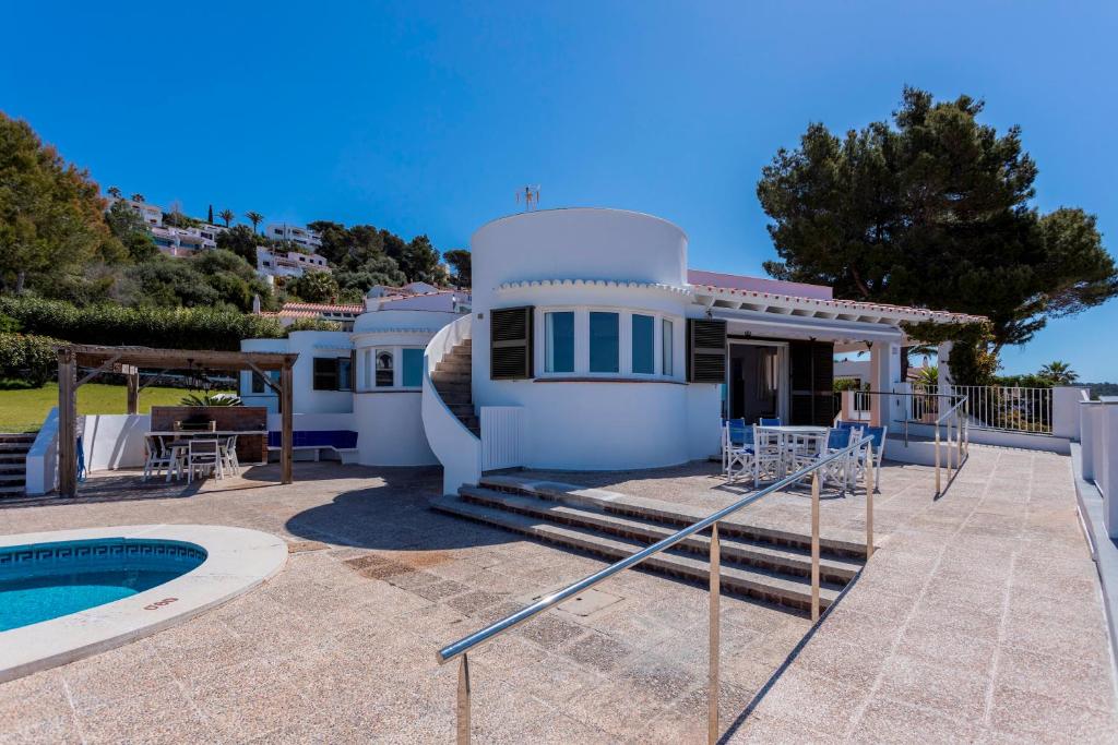 a villa with a swimming pool and a house at V206 Villa Isabel in Son Bou