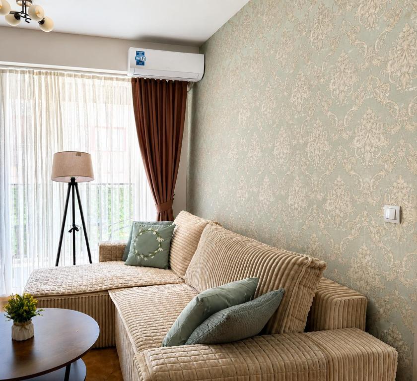 a living room with a couch and a table at Central Apartments Kukoski Near Lake & Old Town in Ohrid