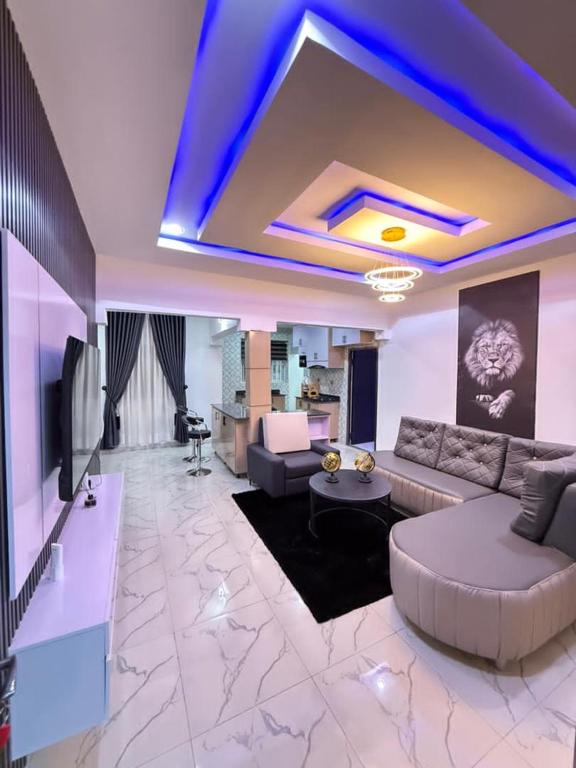 a living room with a couch and a table at The Palm Luxe Apartment in Calabar
