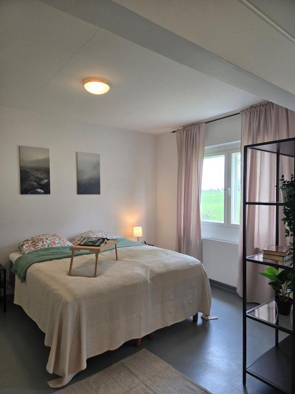 a bedroom with a large bed and a window at Kyyveden Kartano Horsma 14 in Mikkeli