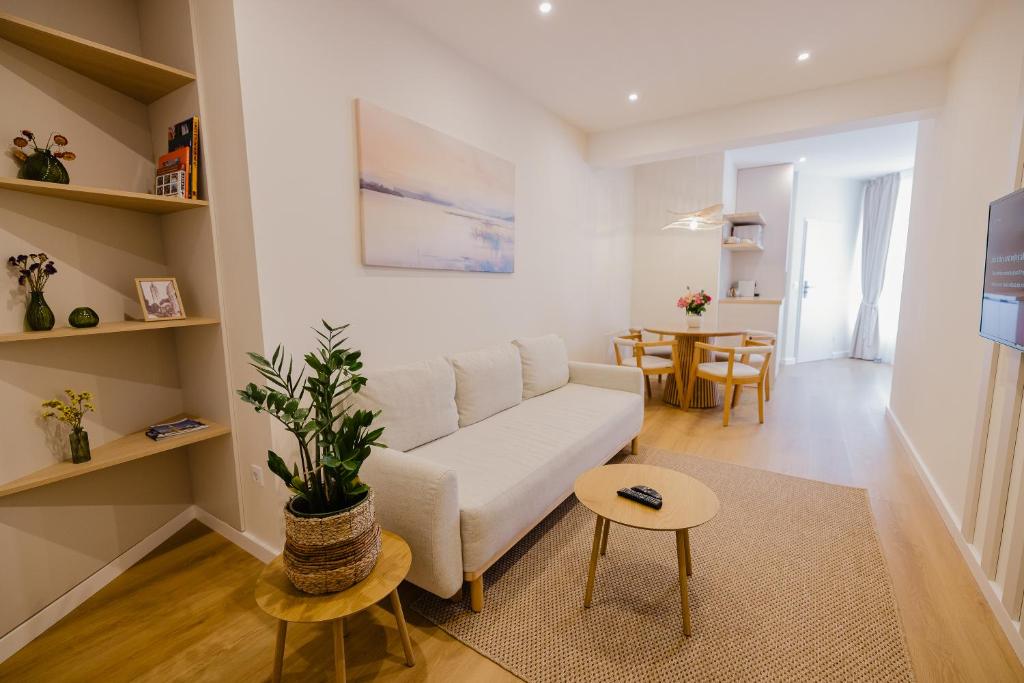 a living room with a white couch and a table at Camelia's cozy place in Baia Mare