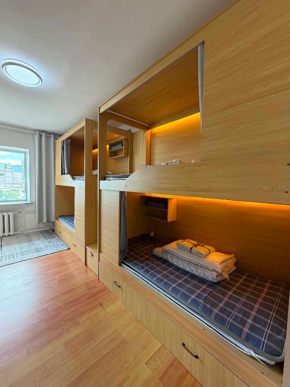 a room with a large wooden bunk bed at GG Hostel MONGOLIA 지지호스텔 몽골 in Ulaanbaatar