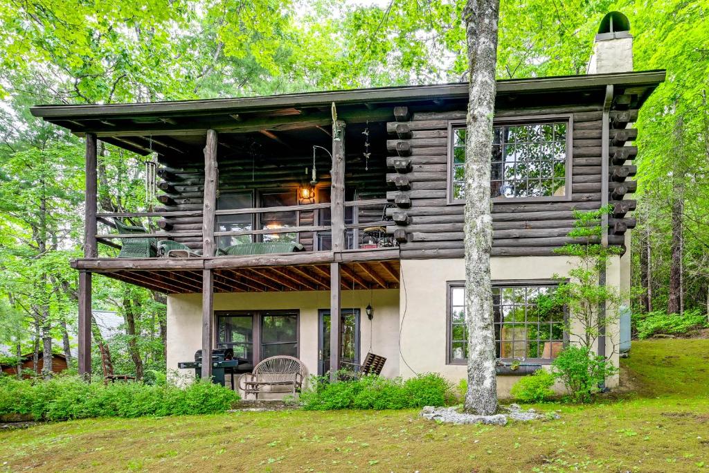 a house in the woods with a wrap around porch at Unplug! Lake Toxaway Cabin w/ Dock Access in Lake Toxaway
