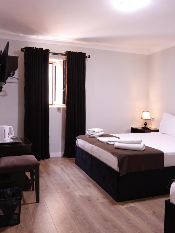 a hotel room with a bed and a window at AL-BUKHARI Boutique Hostel in Bukhara