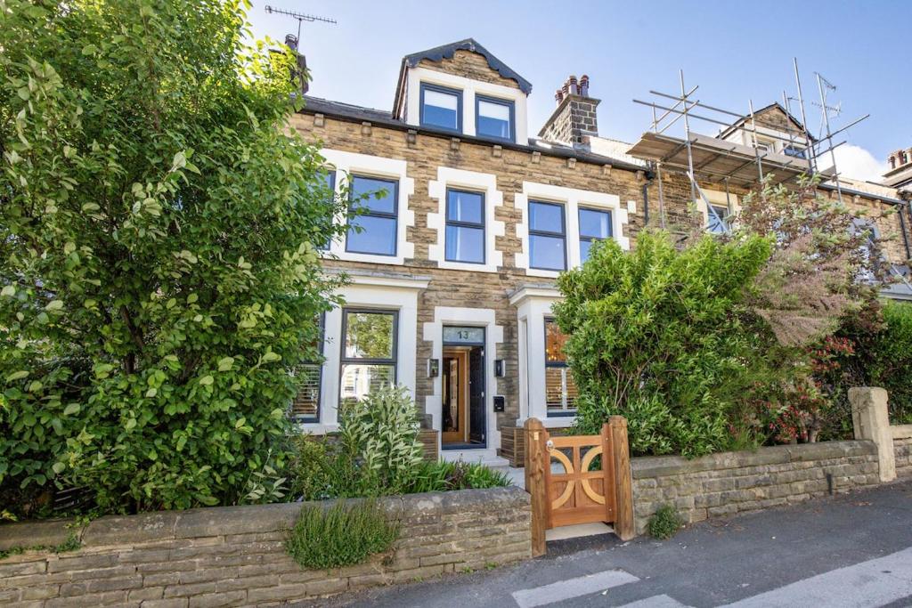 a brick house with a gate in front of it at Spacious Central Harrogate Retreat in Harrogate