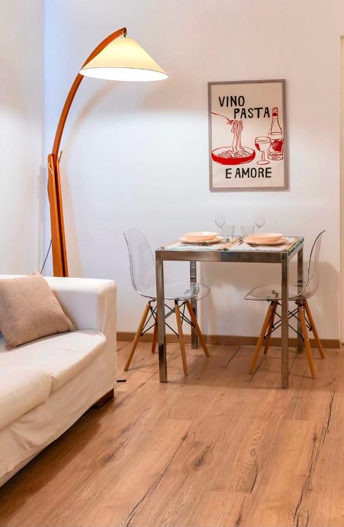 a living room with a table and a couch at torre poesia in Trani