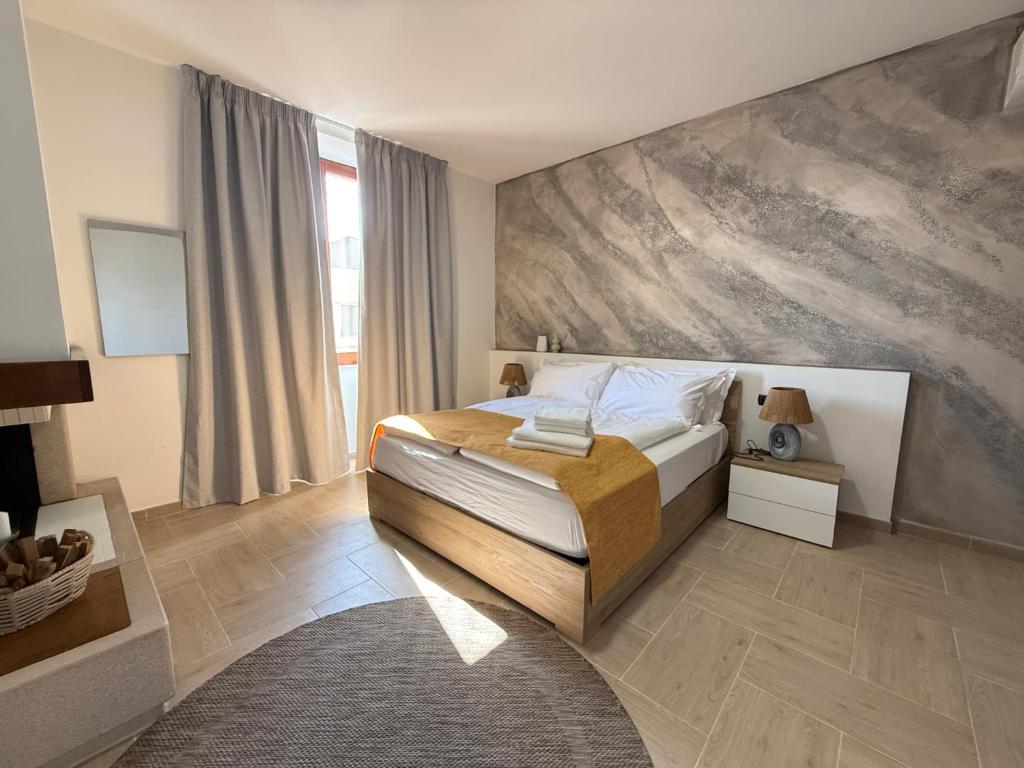 a bedroom with a bed with a painting on the wall at Holmann Haus in Olbia