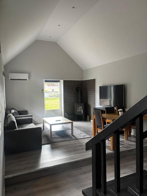 a living room with a couch and a table at Mysigt litet hus in Näsum