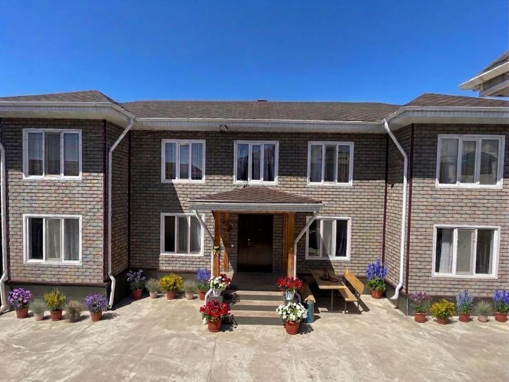 a brick house with flowers in front of it at Diamond in Cholpon-Ata