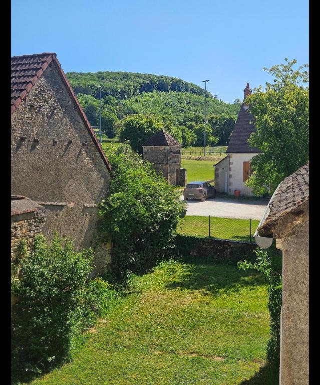 a view of a village with houses and a road at Church View Apartments in Châteauneuf-Val-de-Bargis