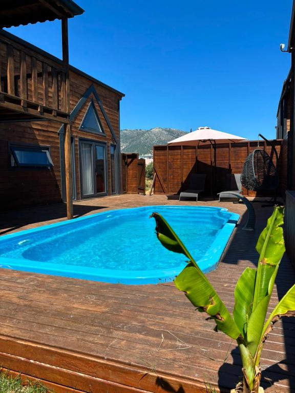 a swimming pool on a deck next to a house at Villa Myra in Beymelek