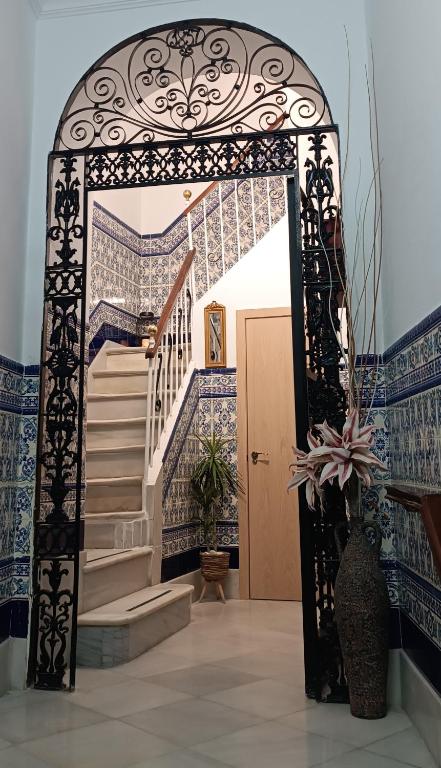 an entrance to a house with a gate and stairs at Hostal Colón Don Miguel in Cádiz