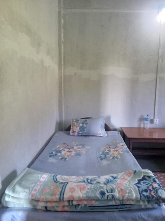 a large bed in a room with a table at Gobrela homestay in Bardiyā