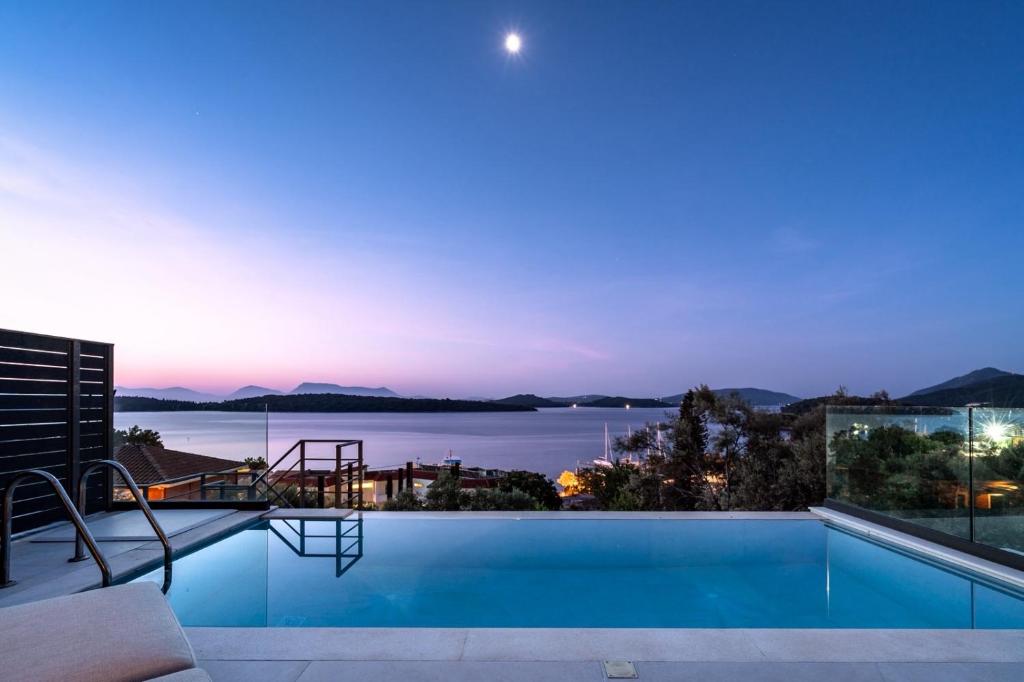 a swimming pool with a view of the water at Villa Incanto in Nydri