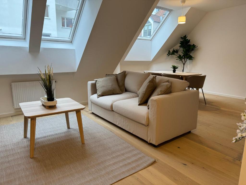 a living room with a couch and a table at Modern Apartment in Döbling in Vienna