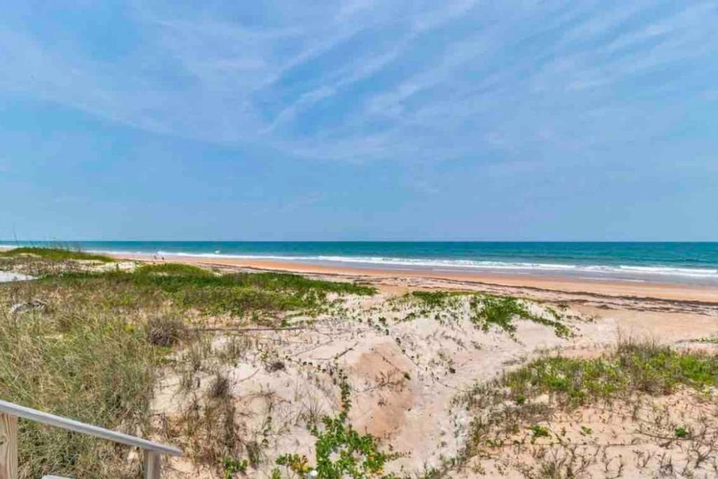 an empty beach with the ocean in the background at Wake up 2 Quiet Ocean Views, centrally located A1A in Ormond Beach