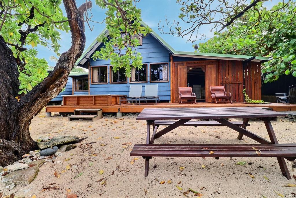 a picnic table in front of a house at Fare Vainina Private beach - Golf in Moorea