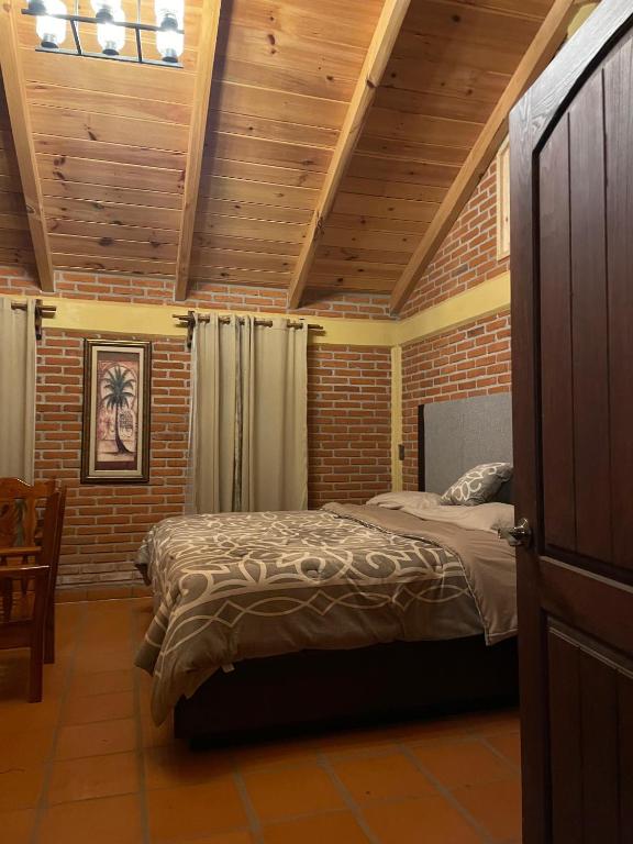 a bedroom with a bed and a wooden ceiling at Zidada Mundo Magico in Huasca de Ocampo