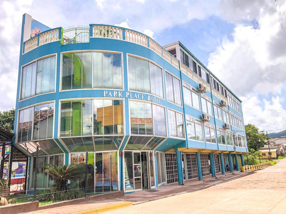 a large blue building with glass windows at Park Place Hotel in Siguatepeque