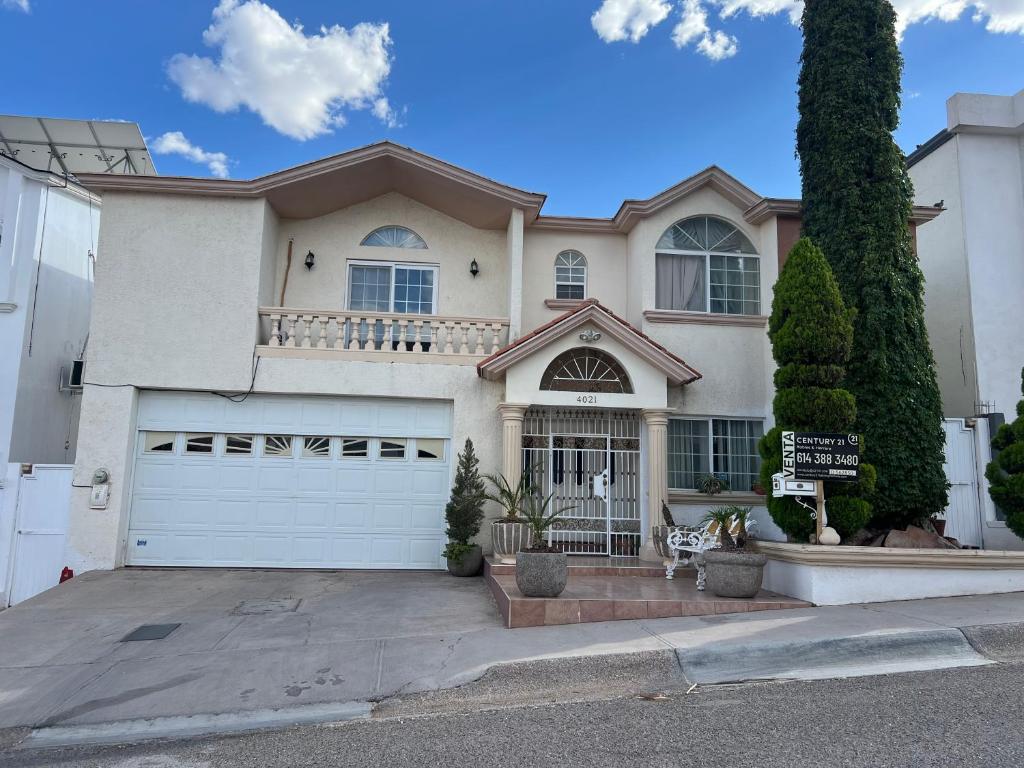 a large house with a white garage at House in a private gated community in Chihuahua