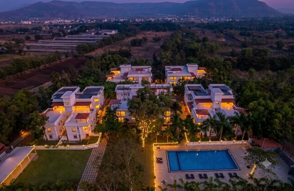 an aerial view of a mansion with a swimming pool at Sterling Stolen Heaven Lonavala in Lonavala