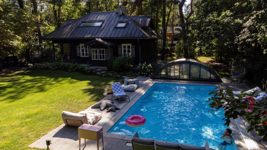 a swimming pool in a yard with a house at Joy Village in Warsaw