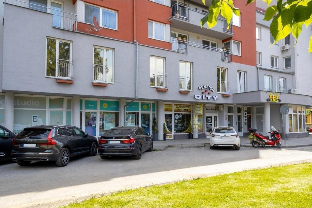 a group of cars parked in front of a building at Penzion City in Púchov